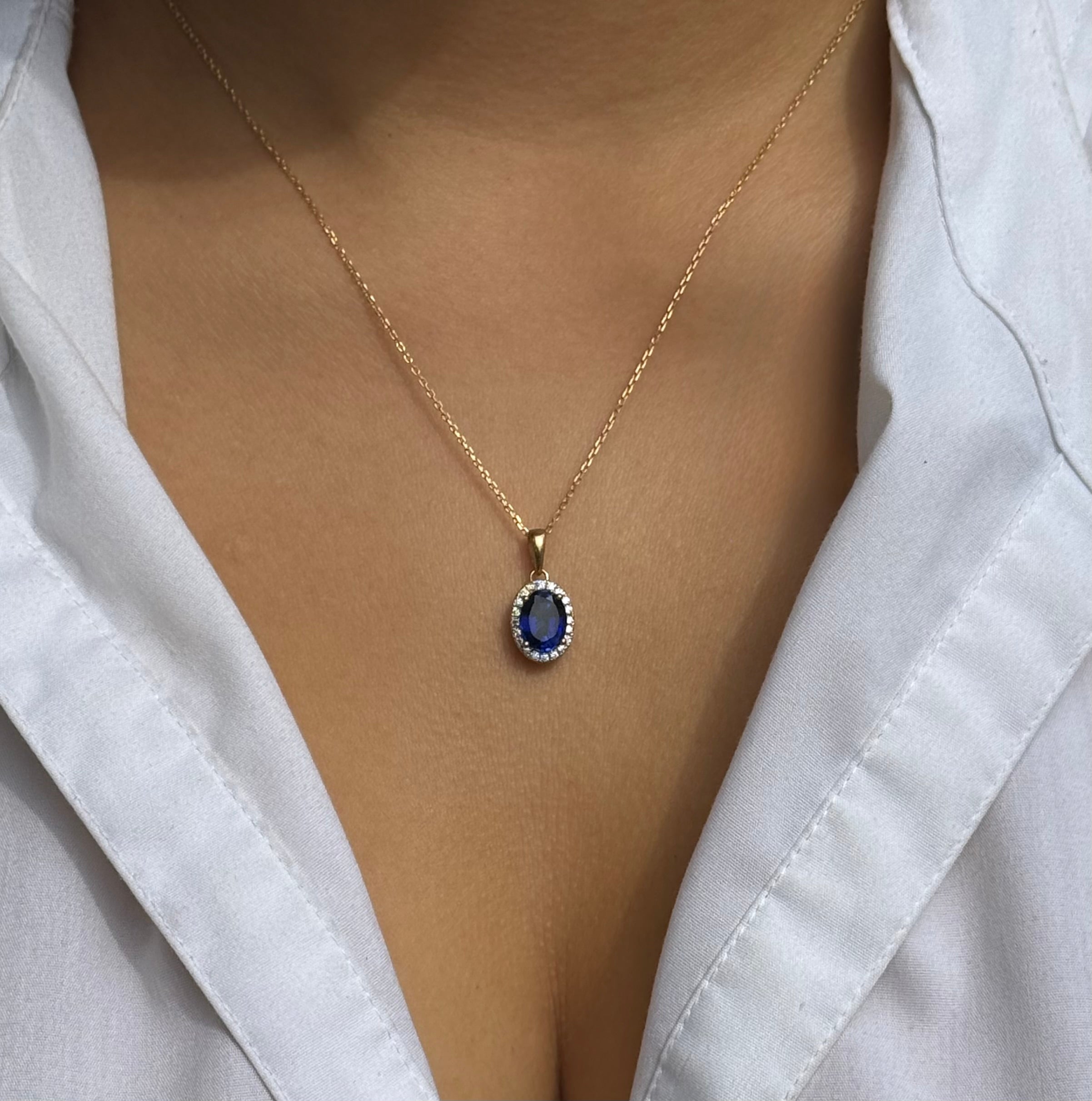 9ct Yellow Gold Oval Blue Stone Pendant with CZ Halo