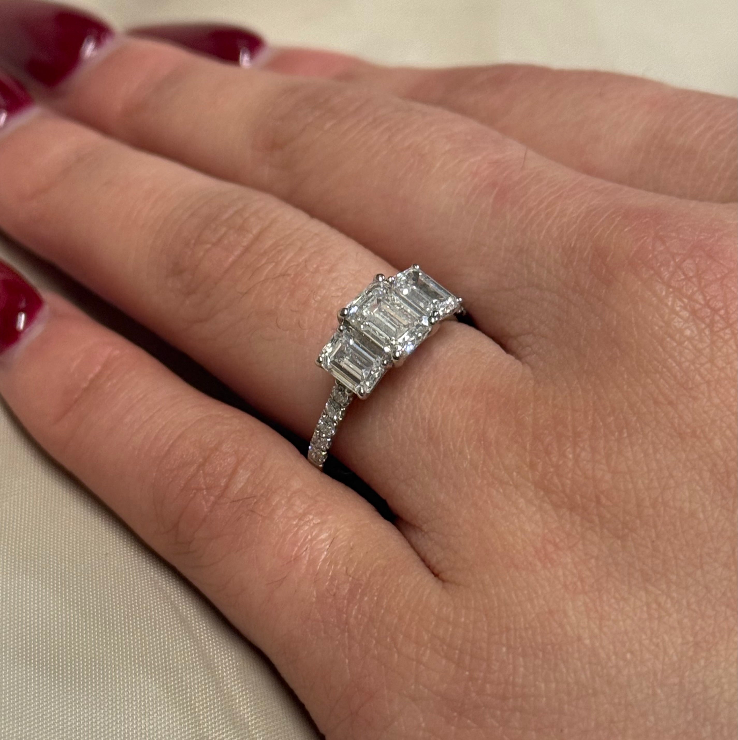 Platinum Three Stone Laboratory Grown Emerald Cut Diamonds with Diamond Band