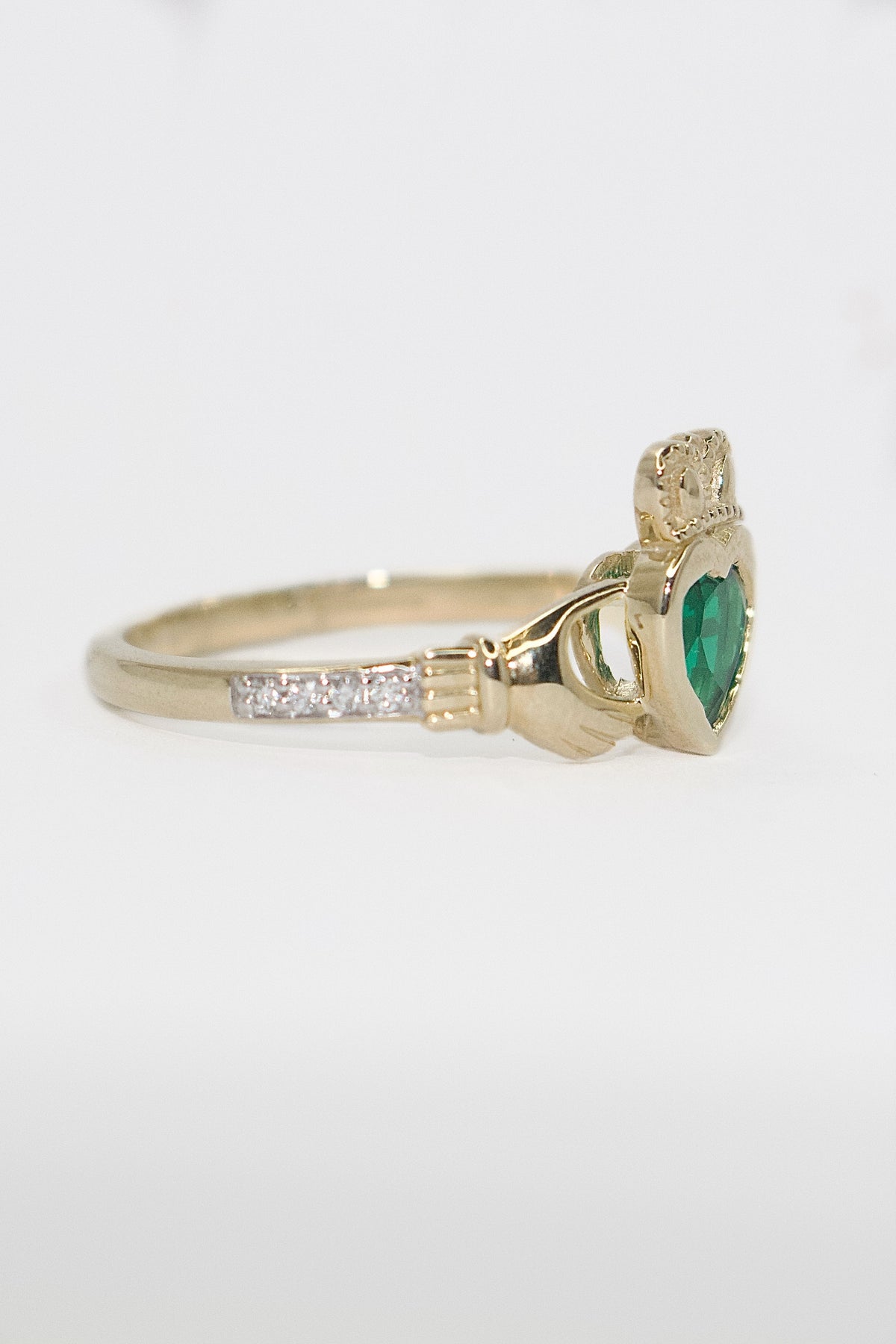 9K Yellow Gold Bezel Set Laboratory Grown Emerald Claddagh with Diamond Shoulders