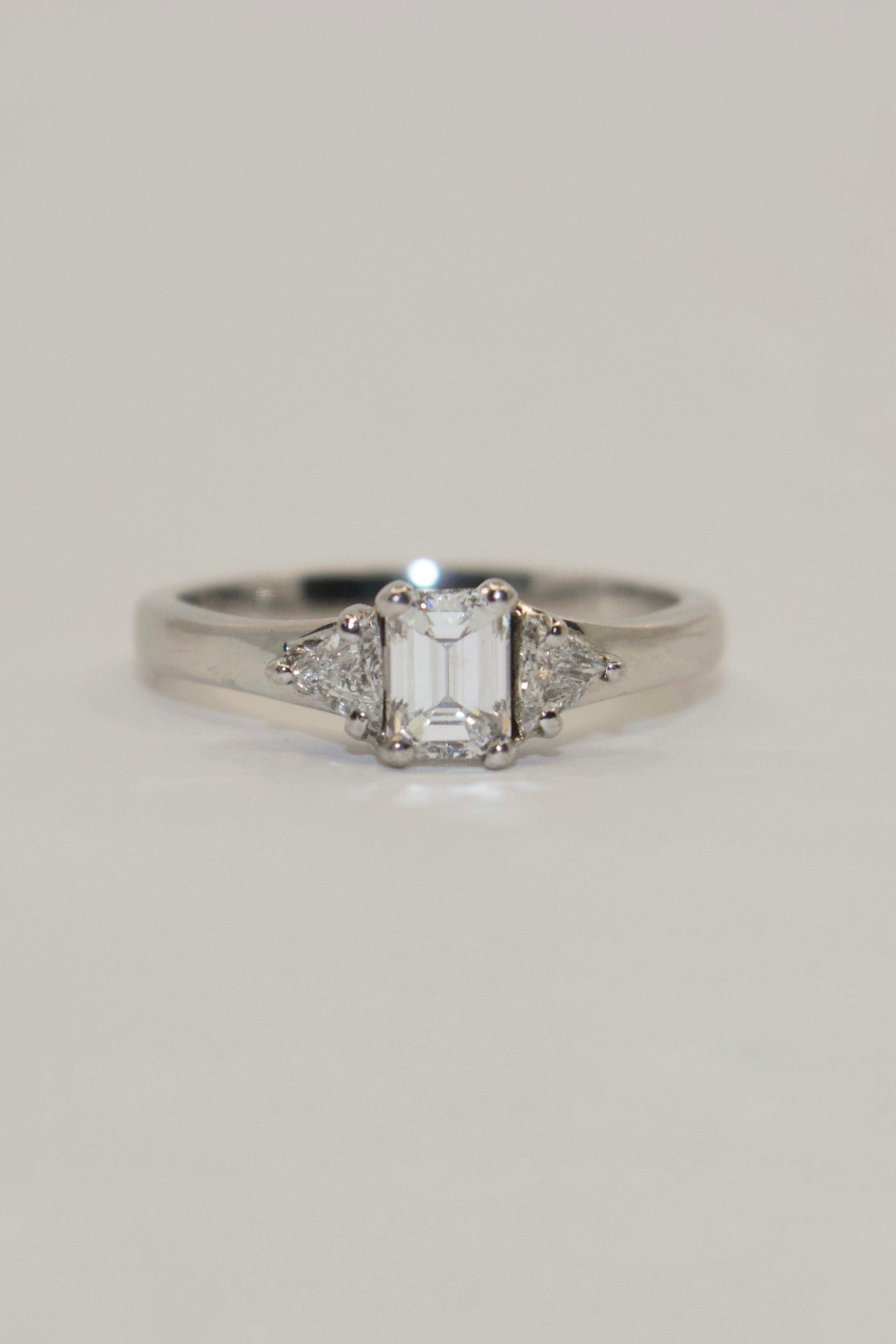 18K White Gold Emerald and Trillion Cut Three Stone Diamond Ring