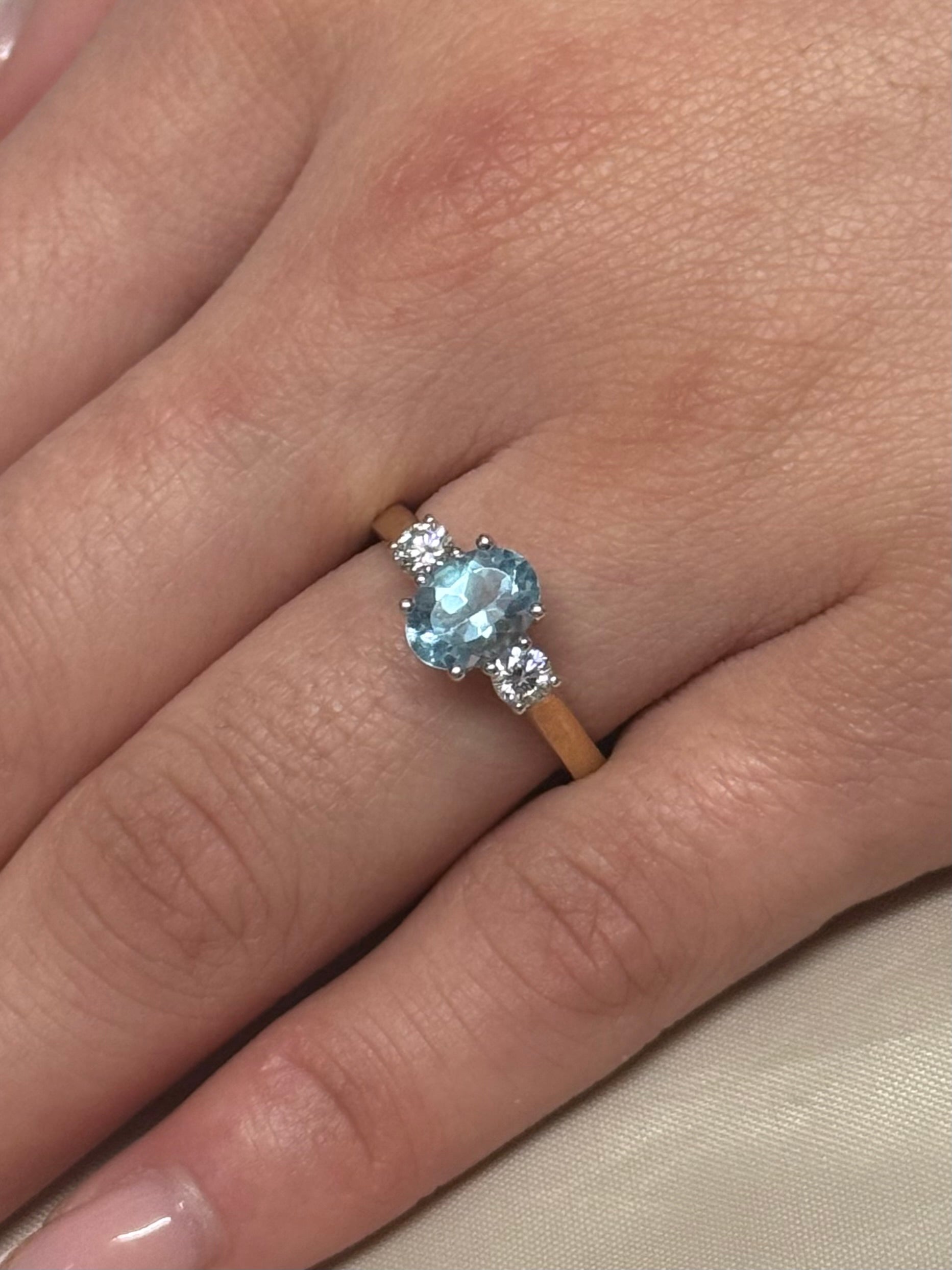 9K Yellow Gold Oval Blue Topaz with Diamond Side Stones