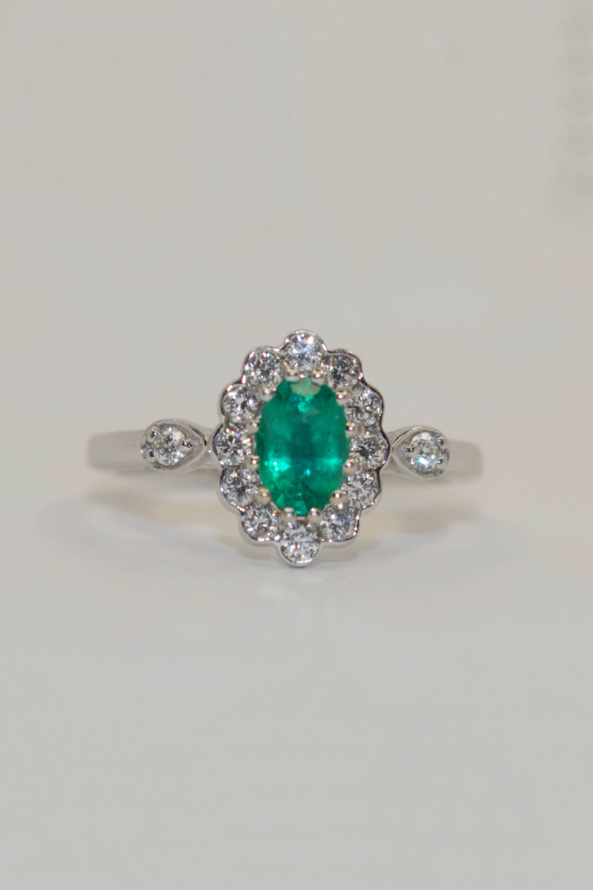 18K White Gold Emerald and Diamond Cluster with Diamond Side Stones