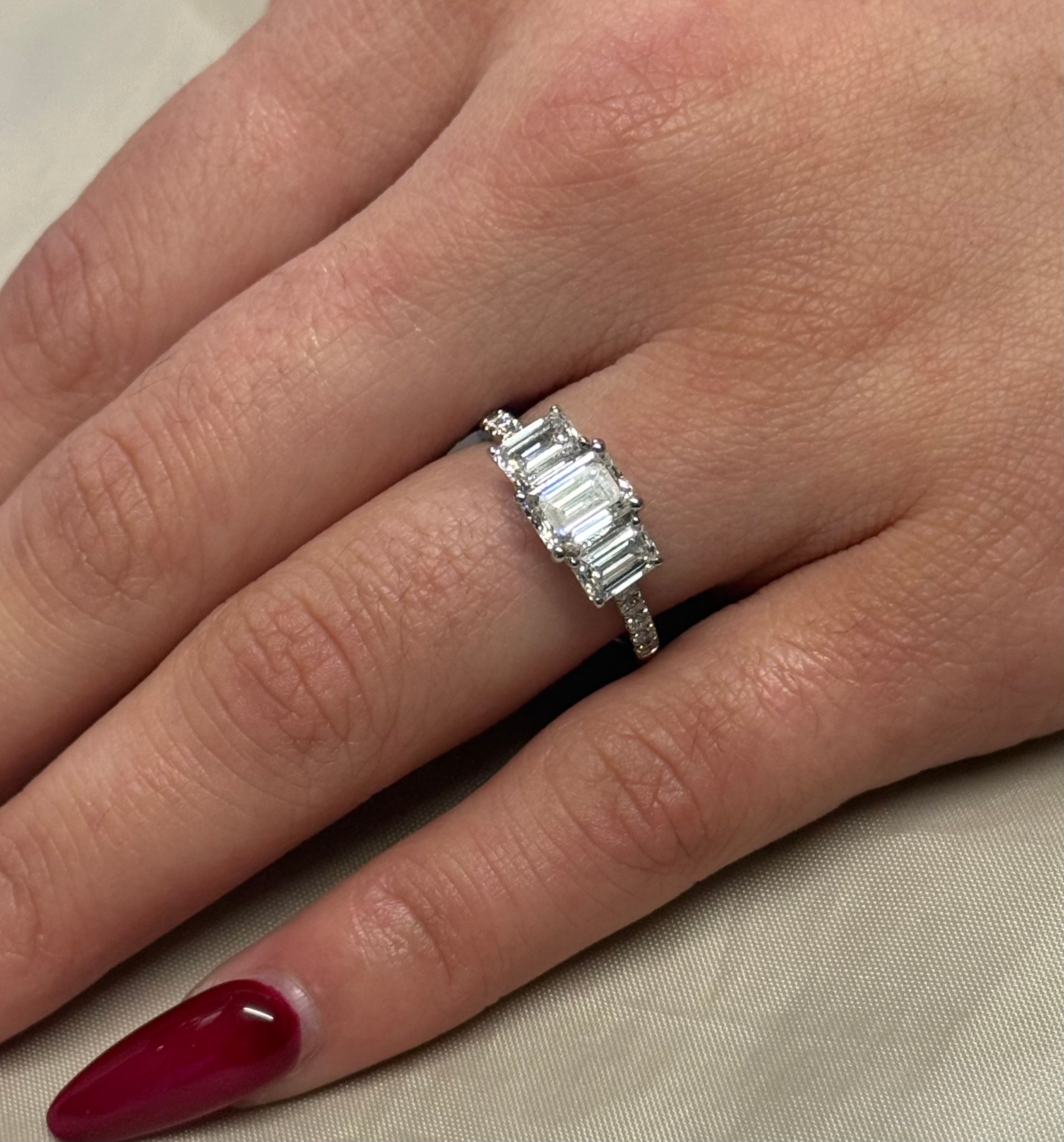 Platinum Three Stone Laboratory Grown Emerald Cut Diamonds with Diamond Band