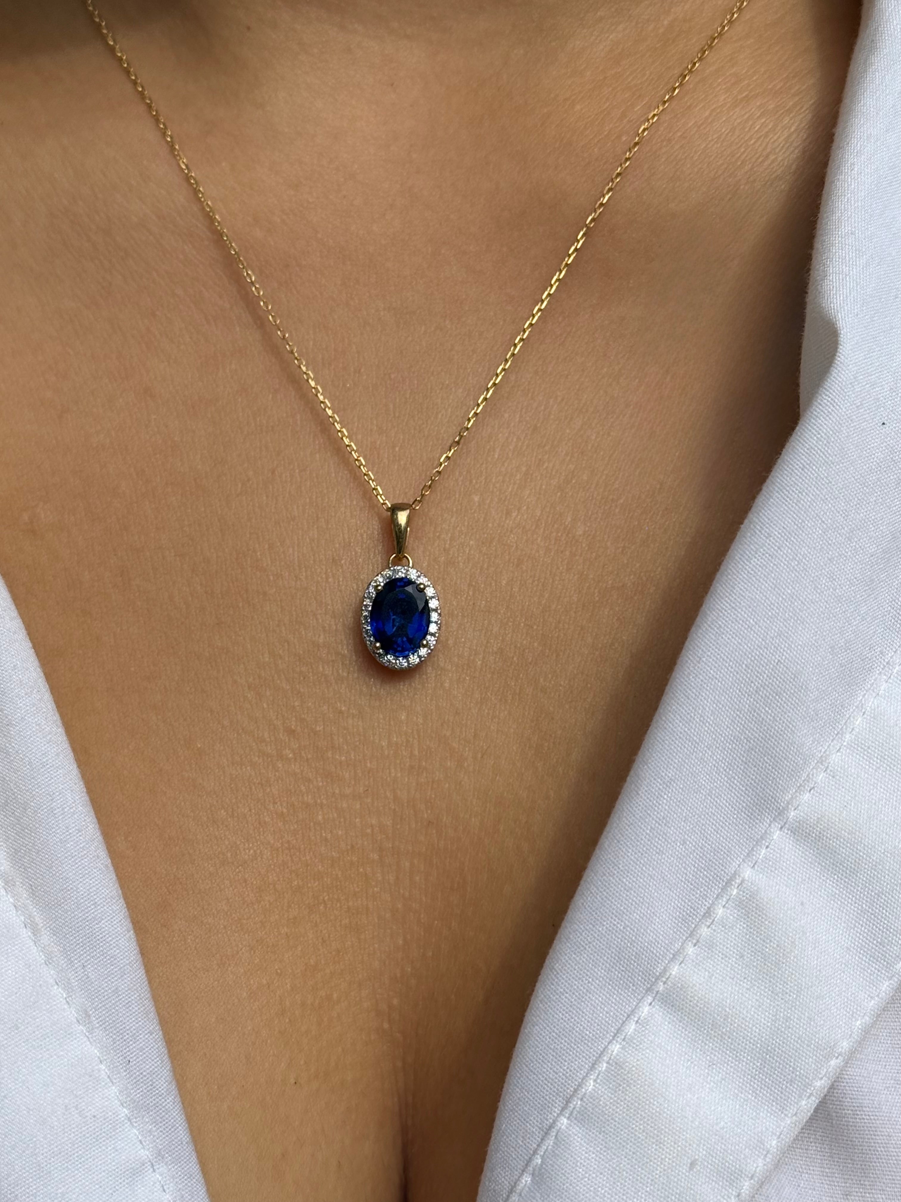 9ct Yellow Gold Oval Blue Stone Pendant with CZ Halo