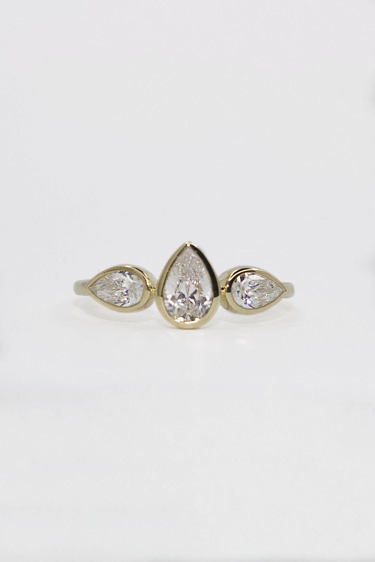 9K Yellow Gold Bezel Set Pear Three Stone CZ Marquise Ring