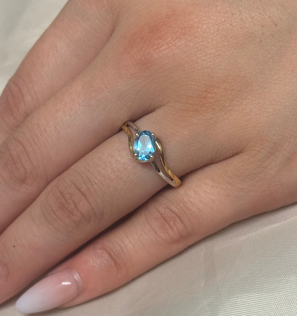 9K Two Tone Diagonal Set Oval Blue Topaz Ring