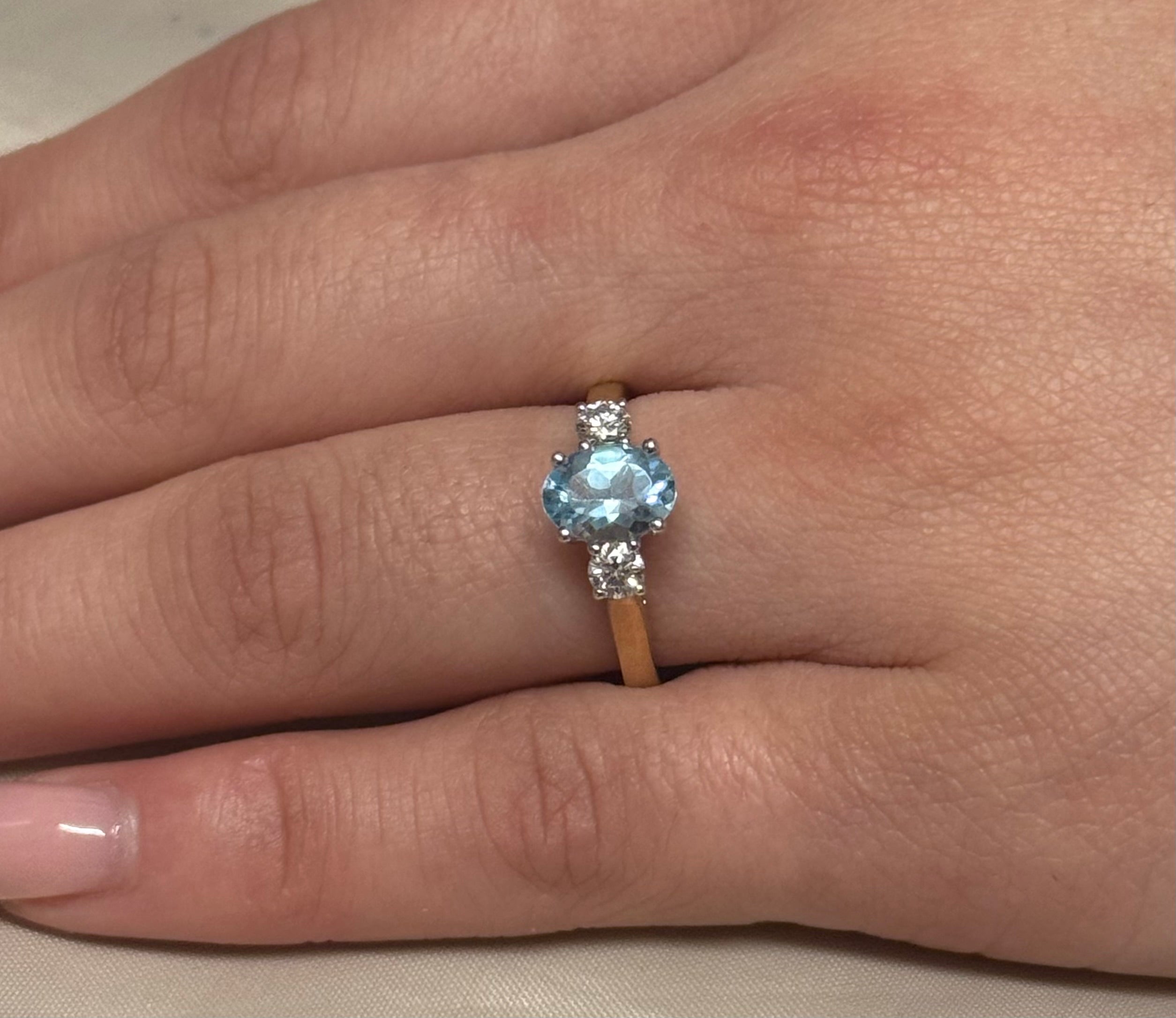 9K Yellow Gold Oval Blue Topaz with Diamond Side Stones