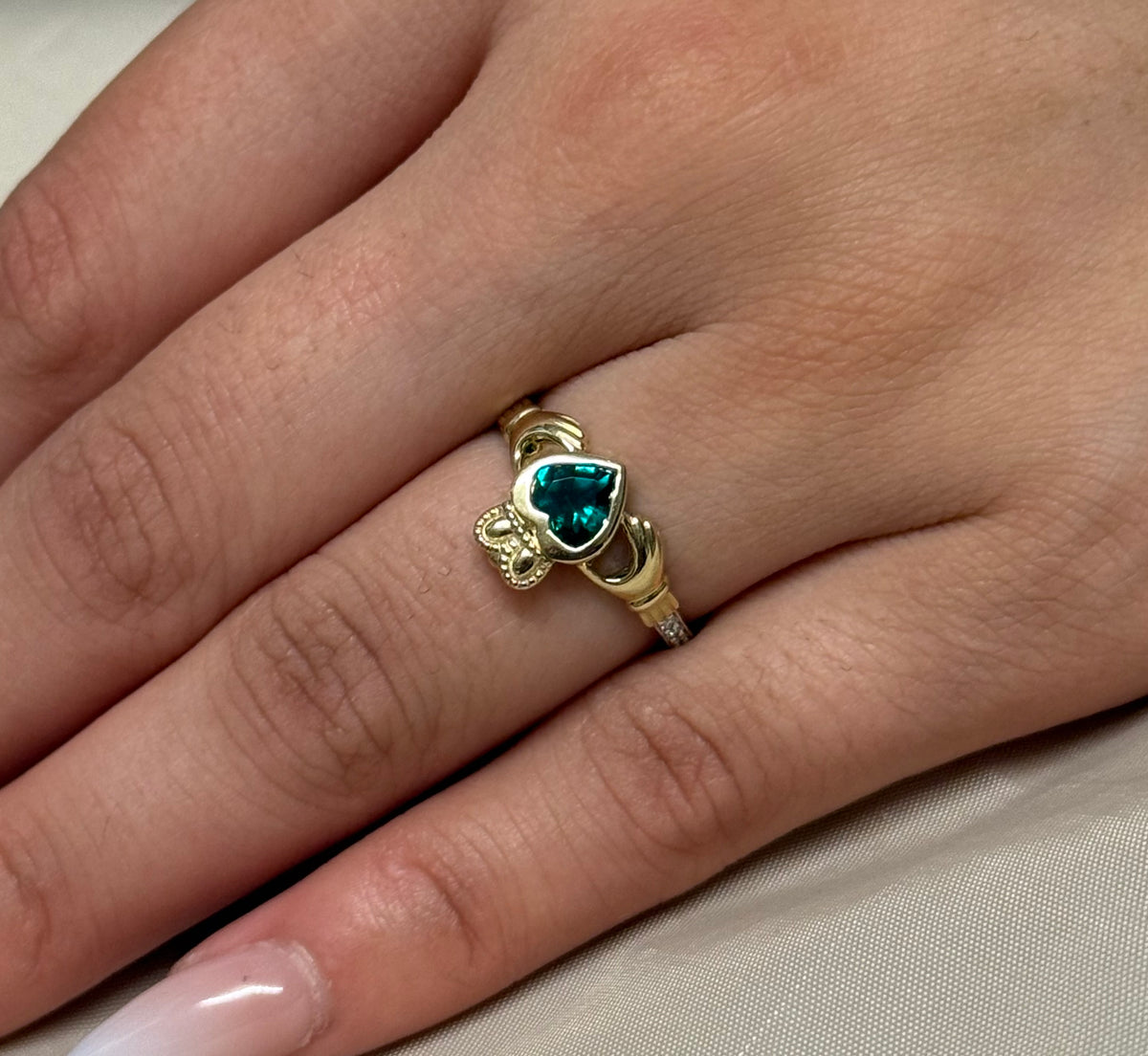 9K Yellow Gold Bezel Set Laboratory Grown Emerald Claddagh with Diamond Shoulders