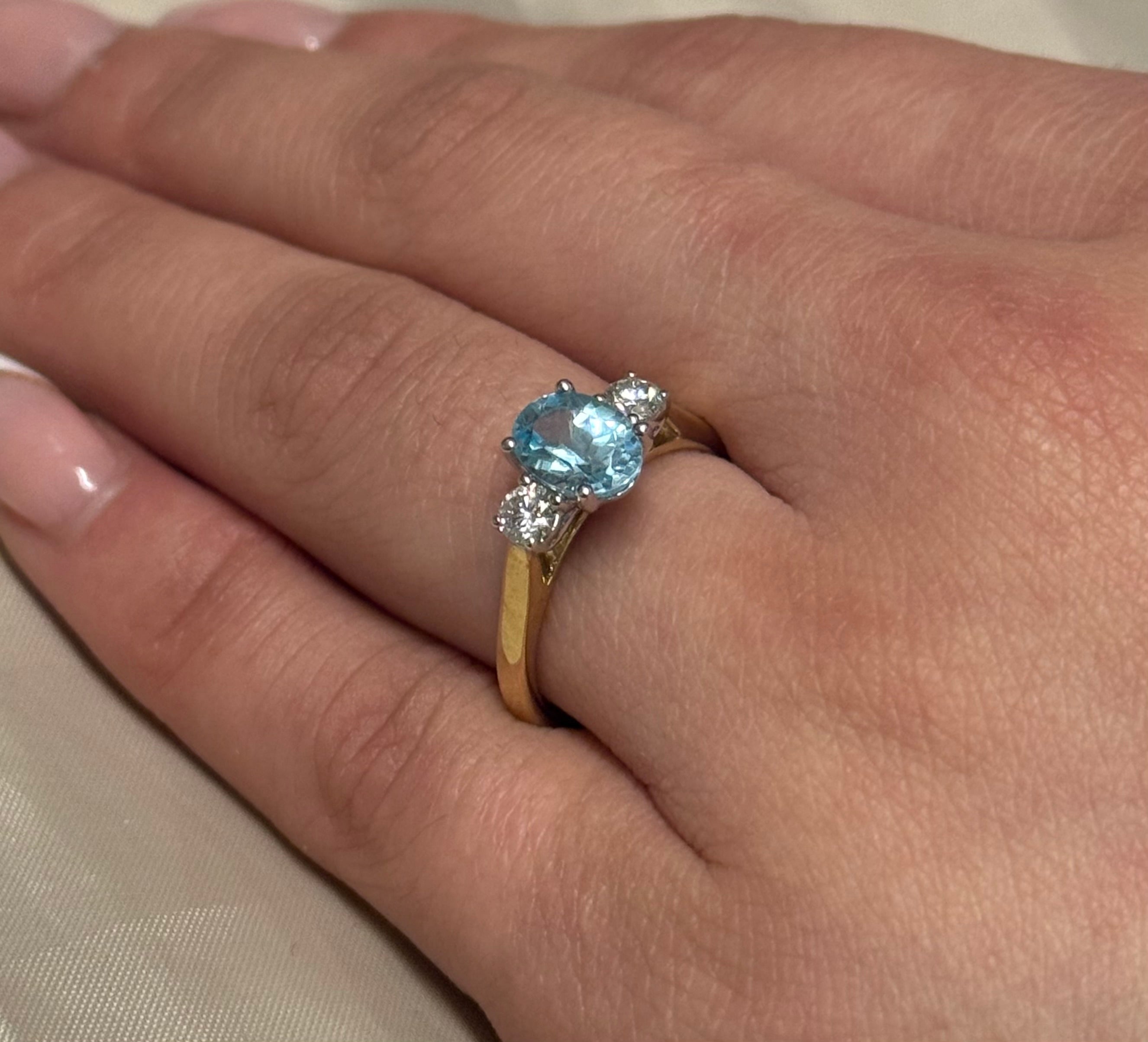 9K Yellow Gold Oval Blue Topaz with Diamond Side Stones