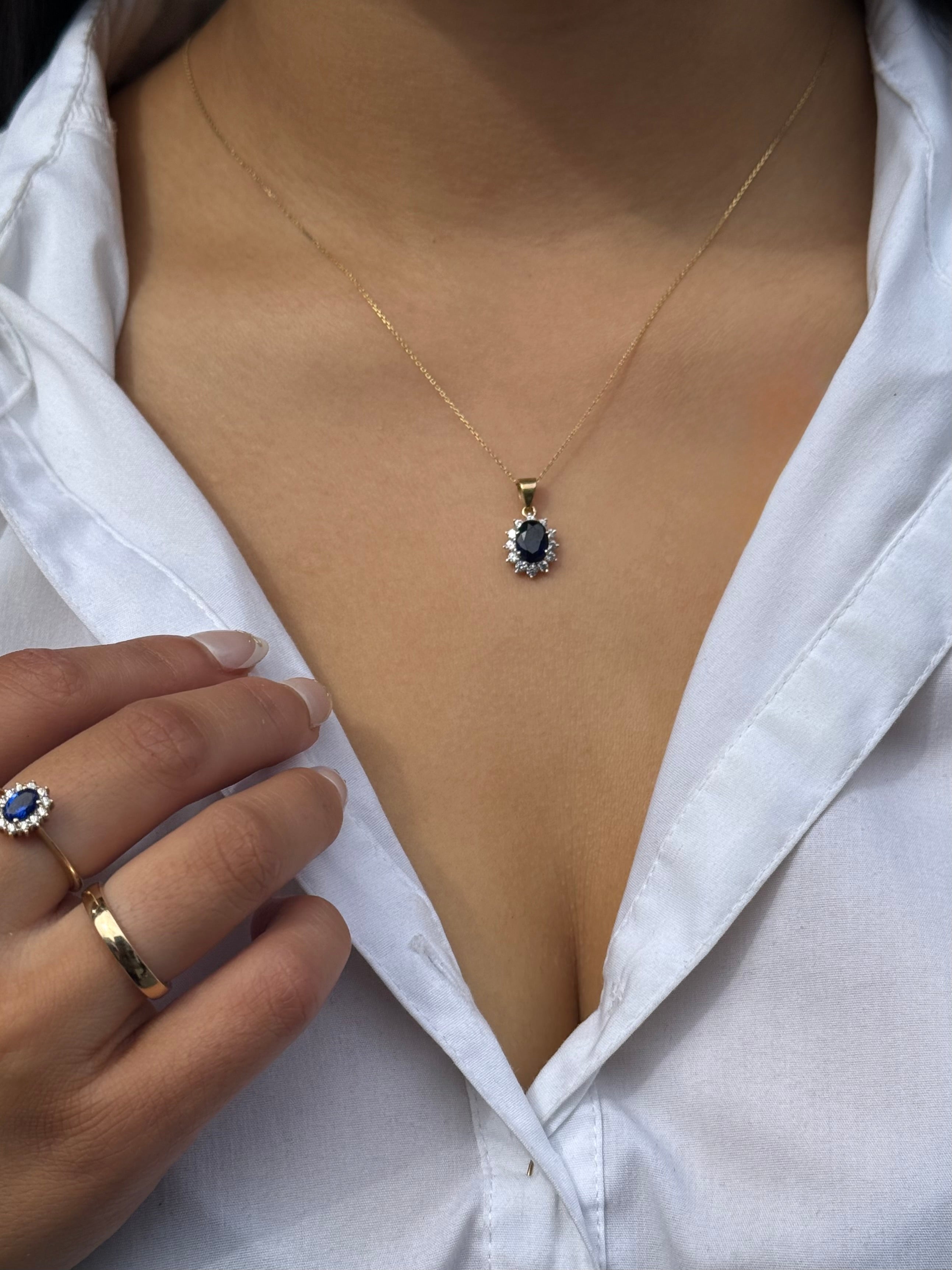 9ct Yellow Gold Oval Blue Stone Pendant with CZ Cluster
