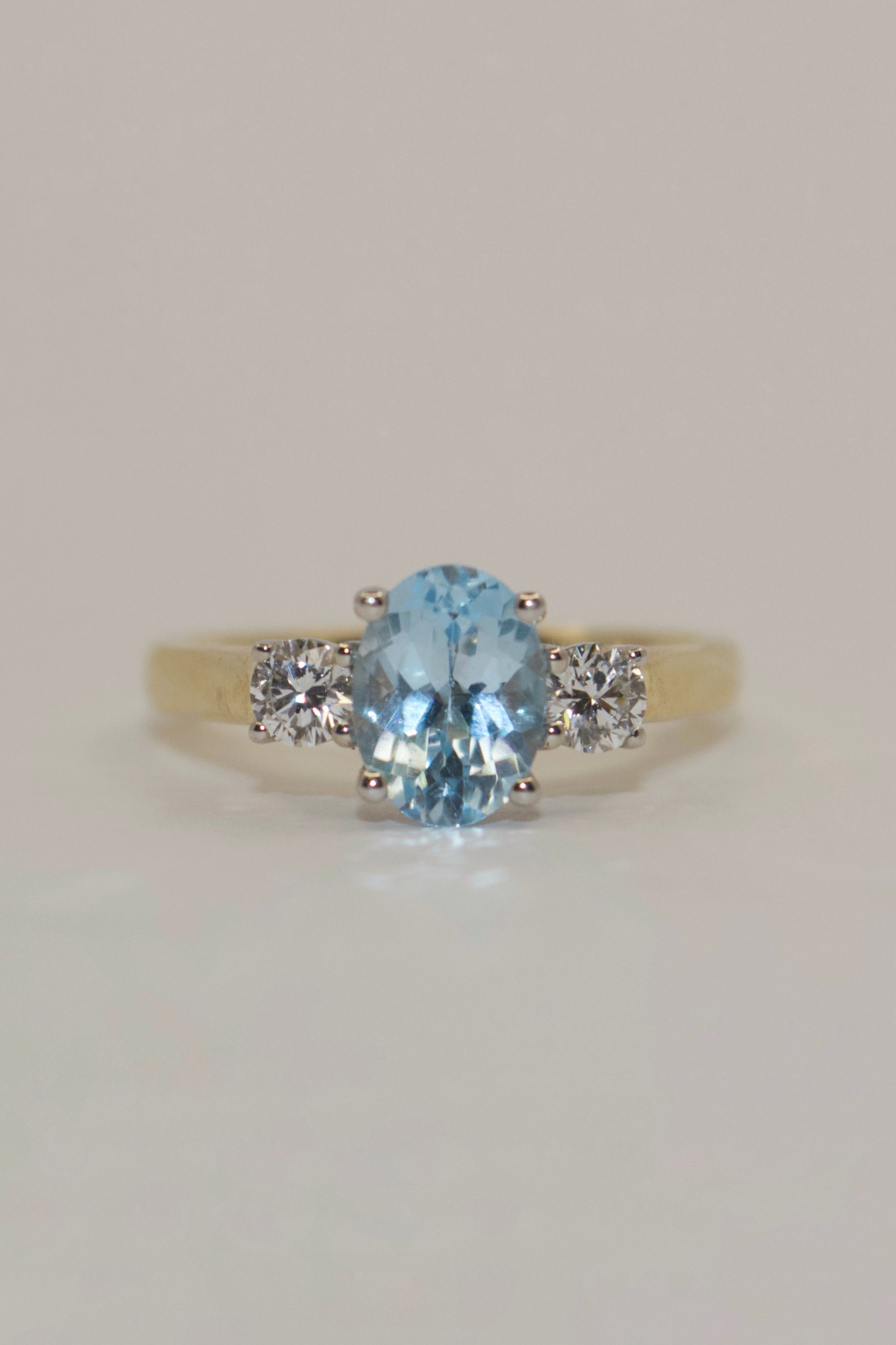 9K Yellow Gold Oval Blue Topaz with Diamond Side Stones