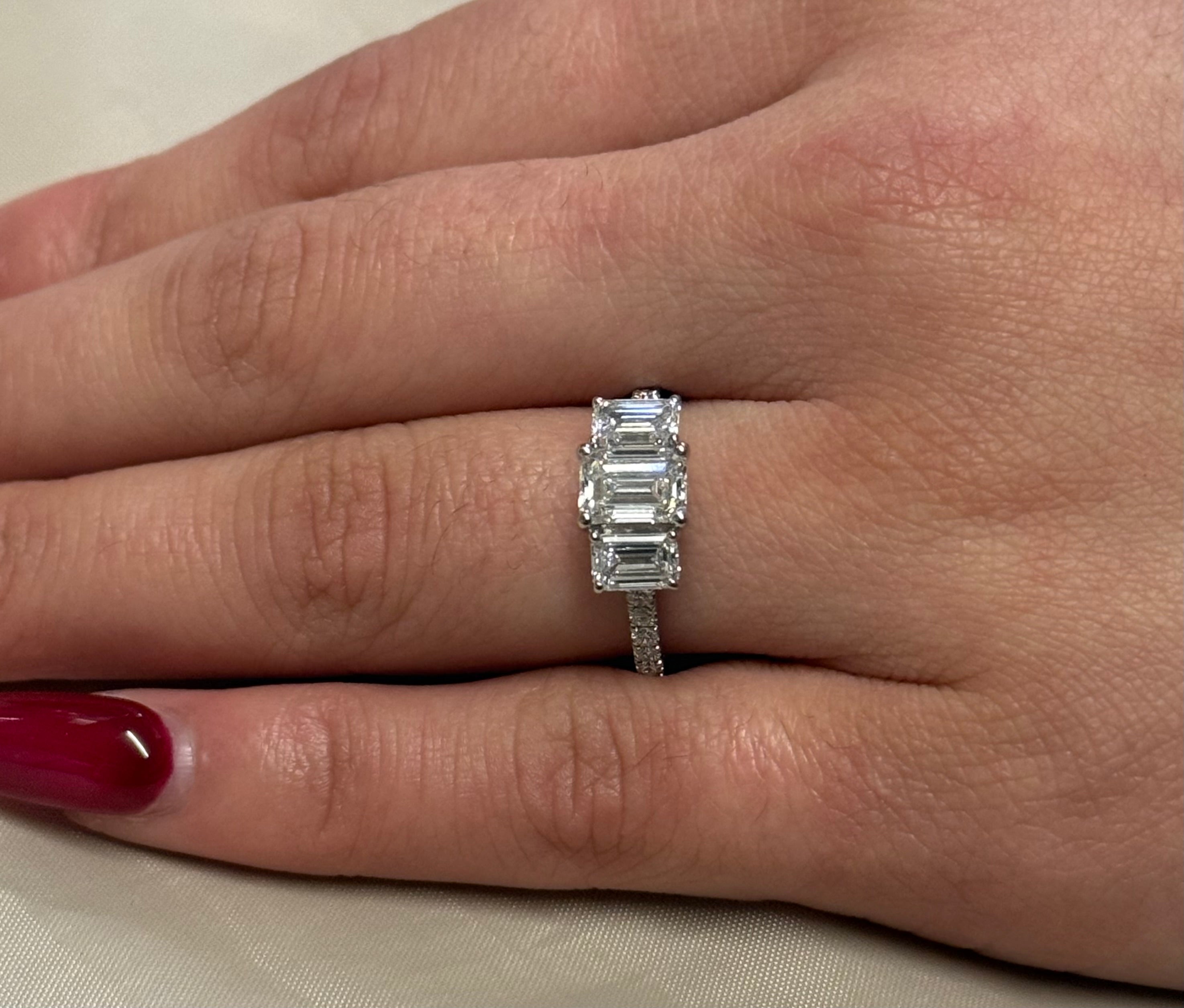 Platinum Three Stone Laboratory Grown Emerald Cut Diamonds with Diamond Band