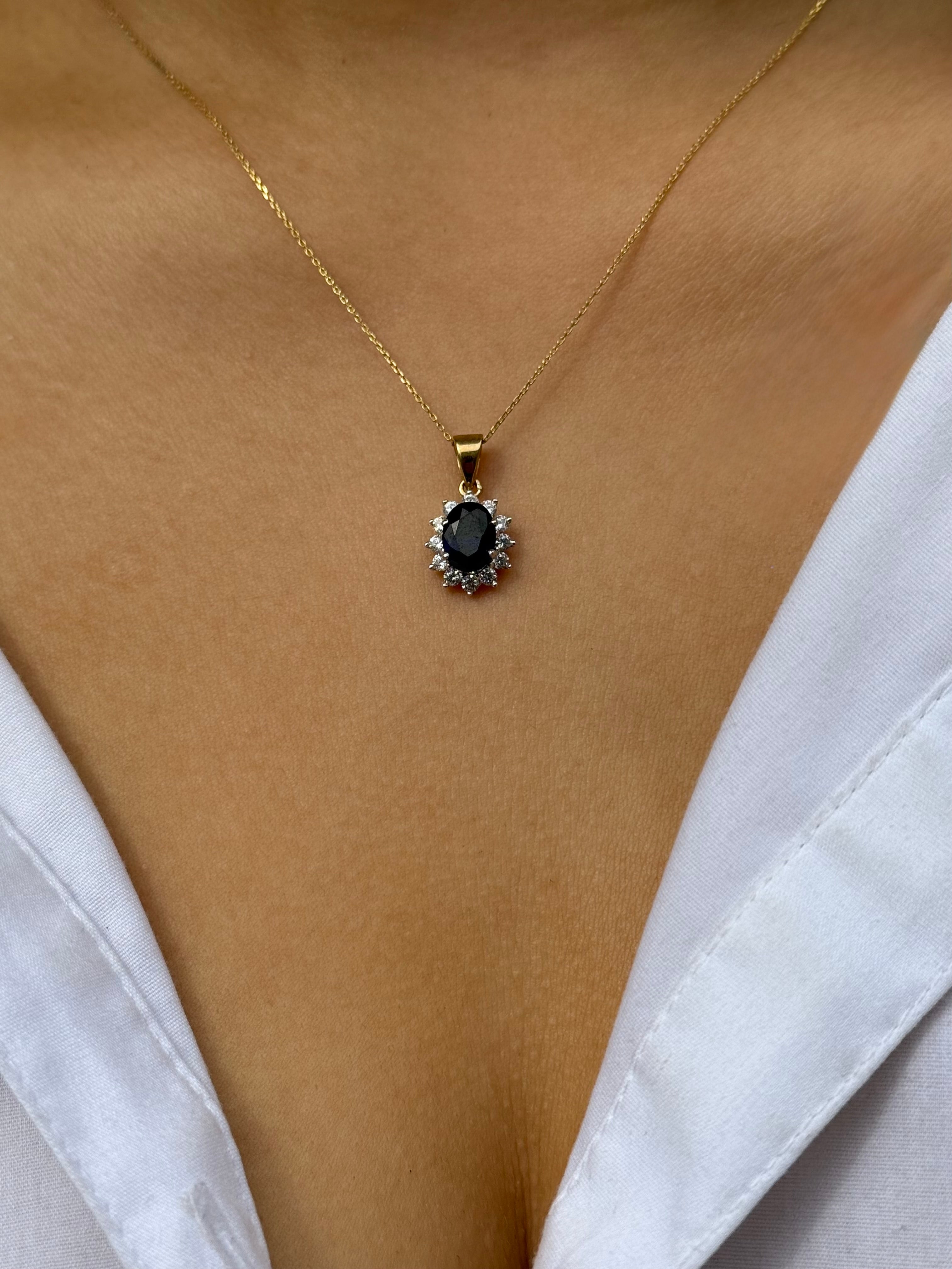 9ct Yellow Gold Oval Blue Stone Pendant with CZ Cluster