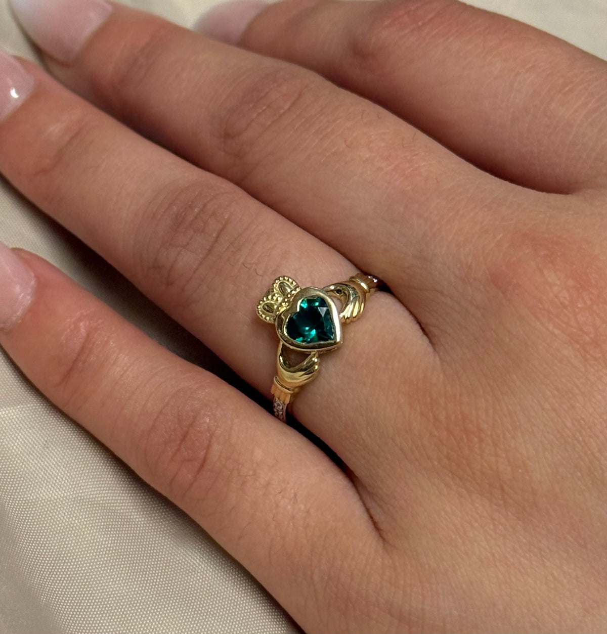 9K Yellow Gold Bezel Set Laboratory Grown Emerald Claddagh with Diamond Shoulders