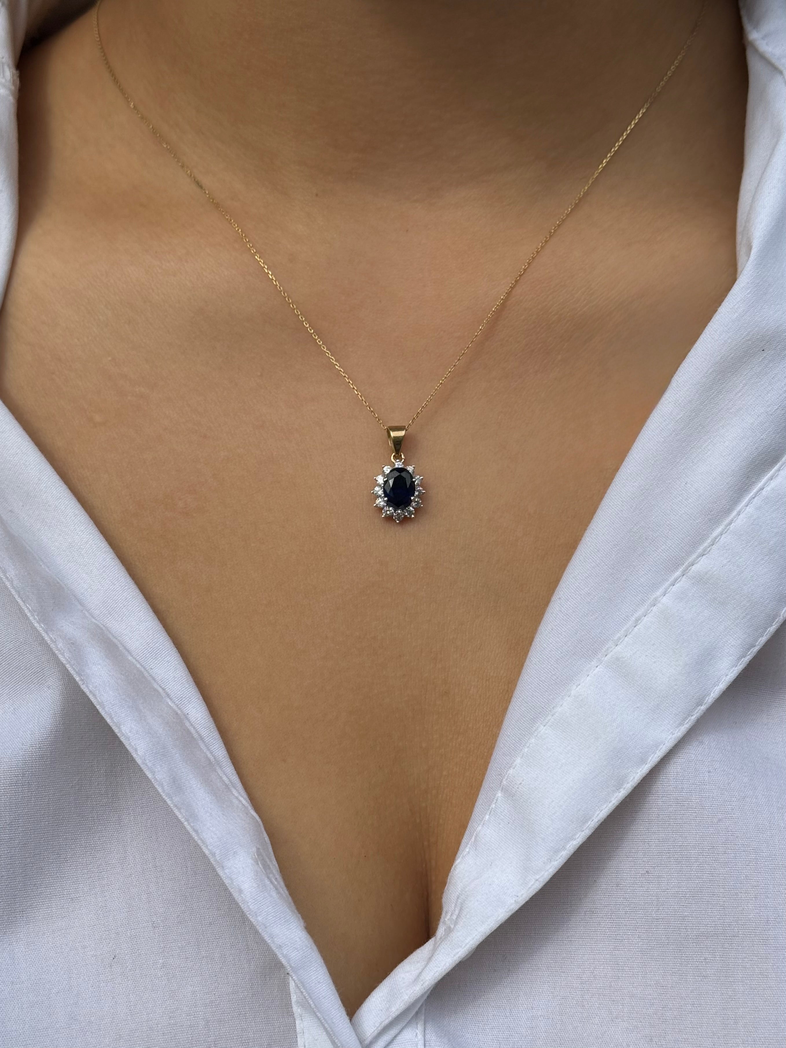 9ct Yellow Gold Oval Blue Stone Pendant with CZ Cluster