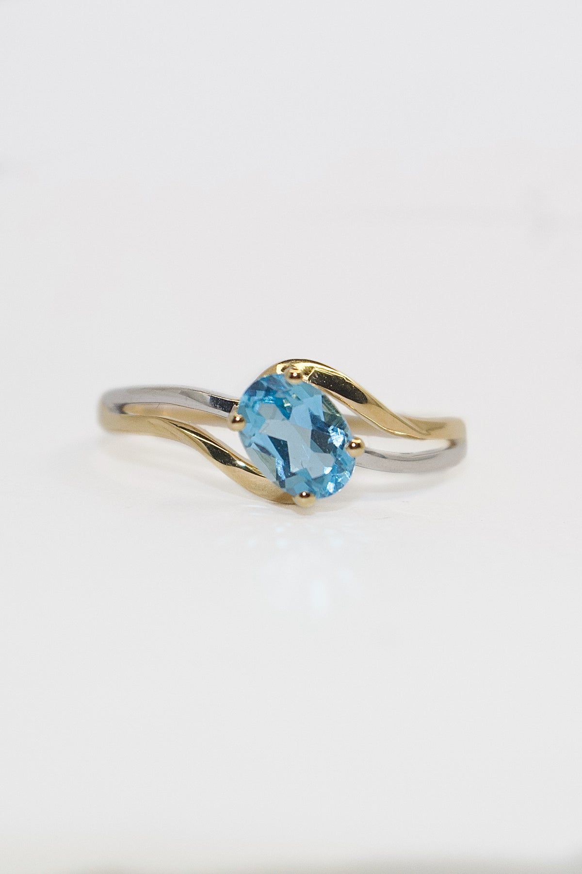 9K Two Tone Diagonal Set Oval Blue Topaz Ring